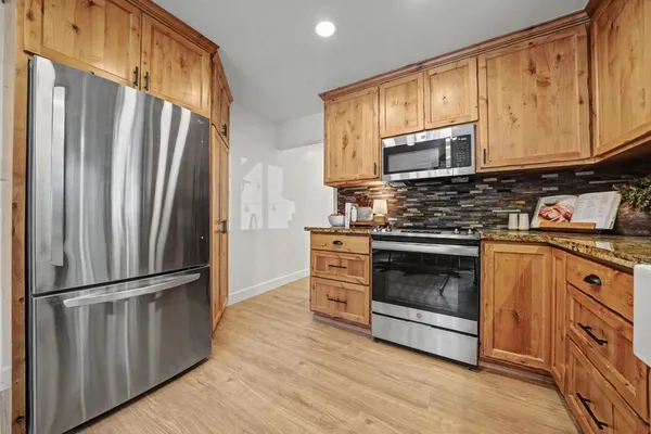 a view of an entryway with wooden floor