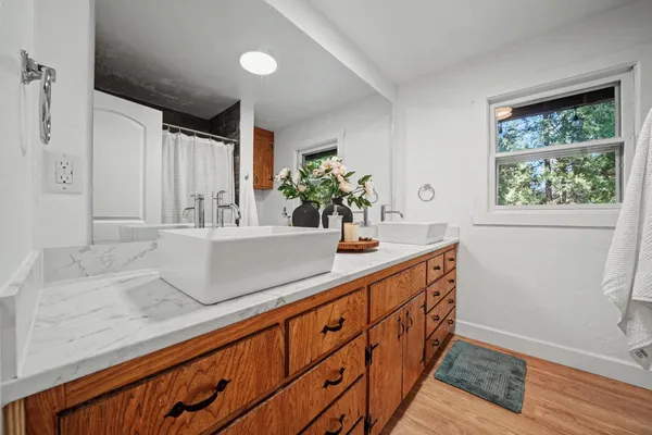 a view of an empty room with wooden floor