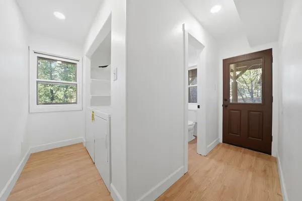 a view of an empty room with wooden floor