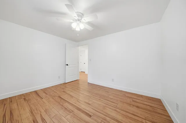 a view of a house with a yard balcony and wooden fence
