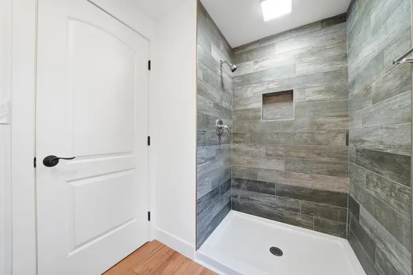 a view of a house with a yard balcony and wooden floor