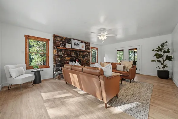 a view of a hallway with wooden floor and a potted plant