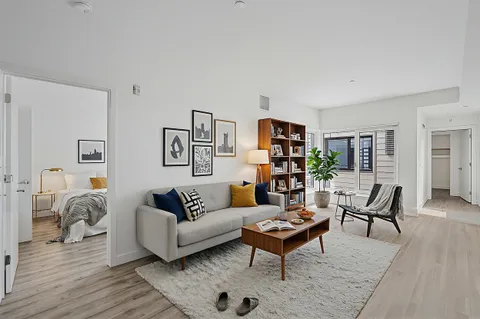 a living room with furniture and wooden floor