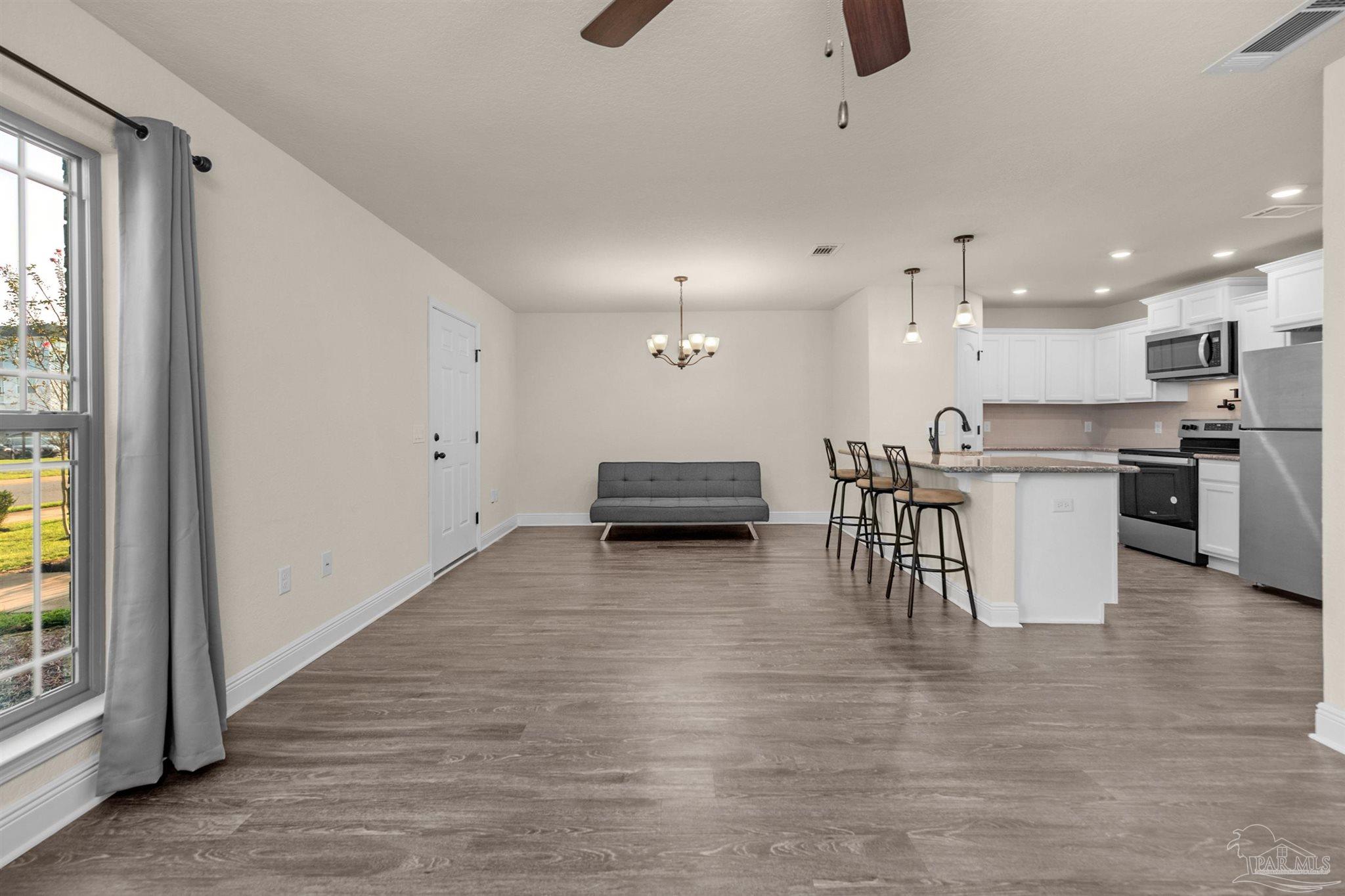 5069 Peach Drive Pace, FL 32571 - Photo 1 of 41 a kitchen with stainless steel appliances kitchen island granite countertop a stove a sink and a refrigerator