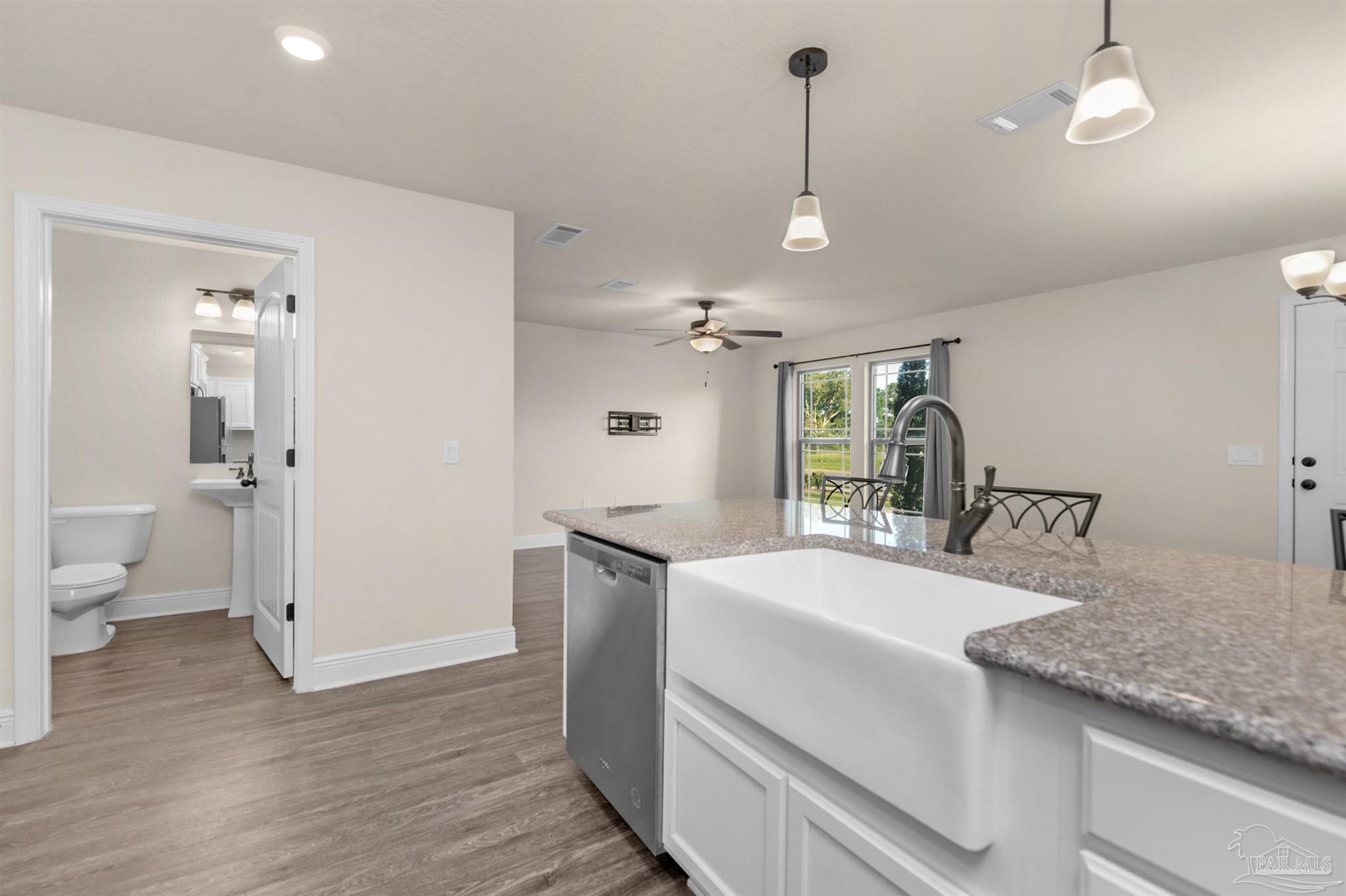 5069 Peach Drive Pace, FL 32571 - Photo 11 of 41 a large white kitchen with a stove a sink and dishwasher