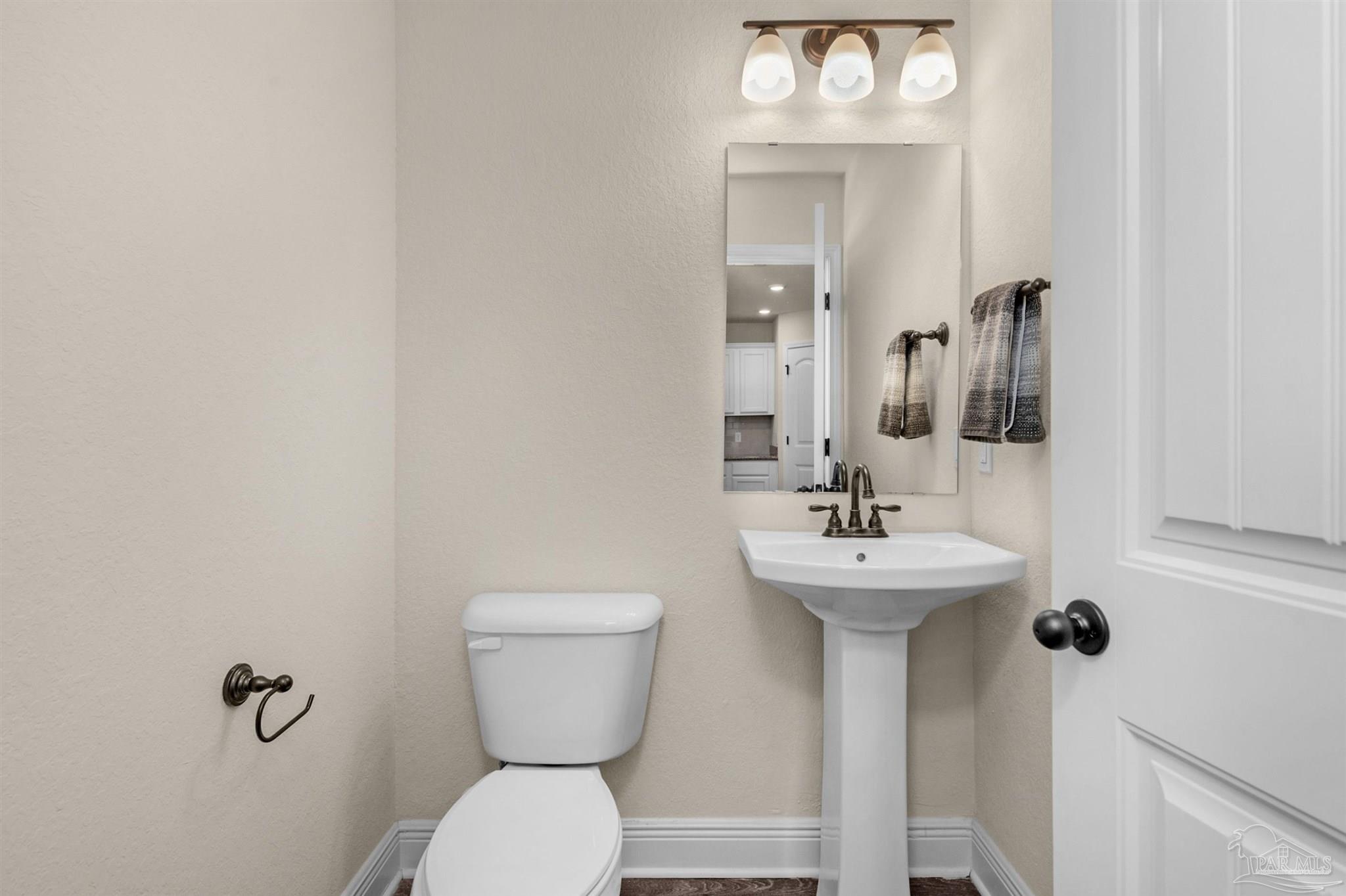 5069 Peach Drive Pace, FL 32571 - Photo 16 of 41 a bathroom with a sink and a mirror