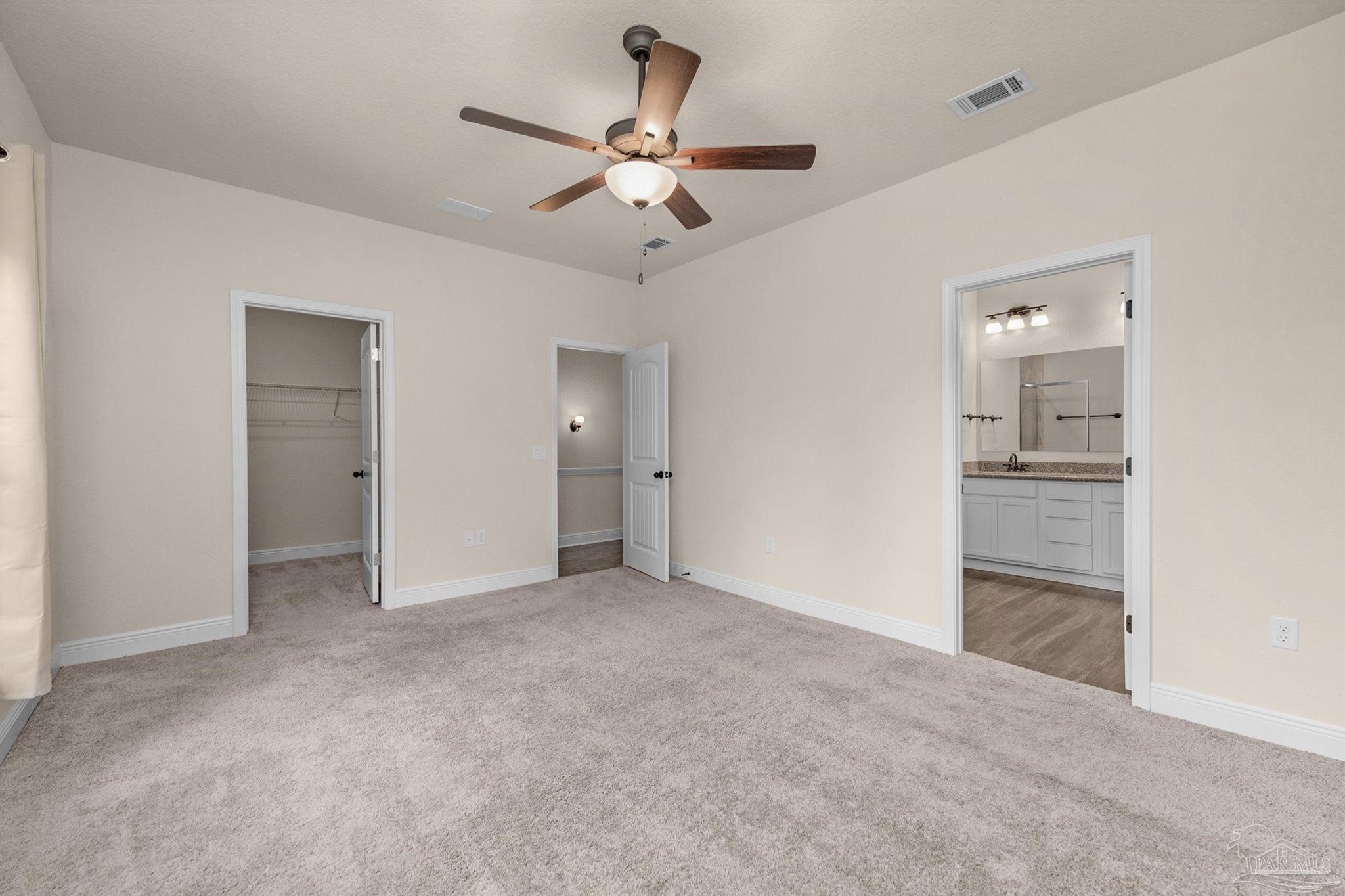 5069 Peach Drive Pace, FL 32571 - Photo 17 of 41 wooden floor in an empty room and a bathroom