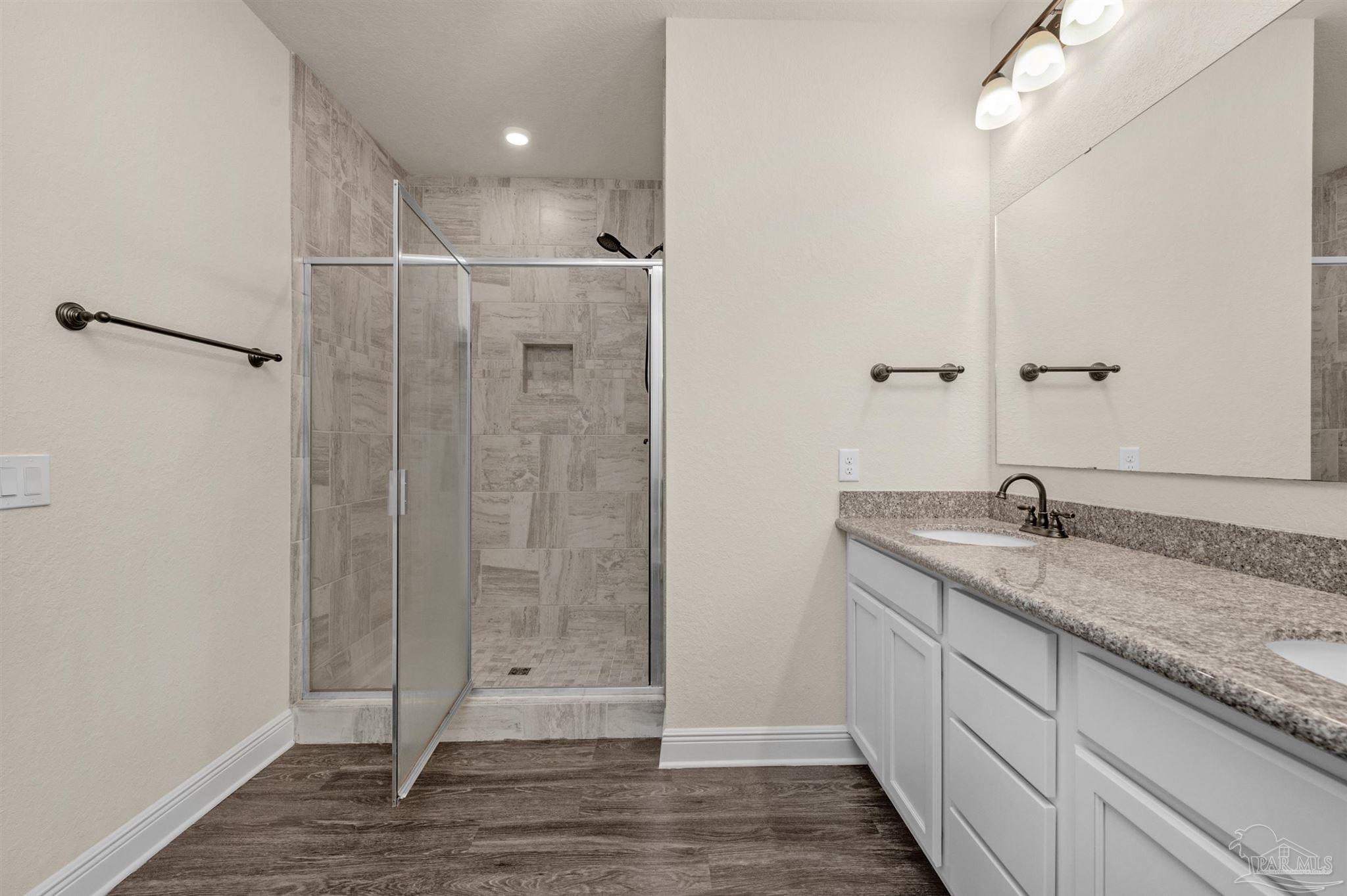 5069 Peach Drive Pace, FL 32571 - Photo 18 of 41 a bathroom with a granite countertop sink a toilet and shower