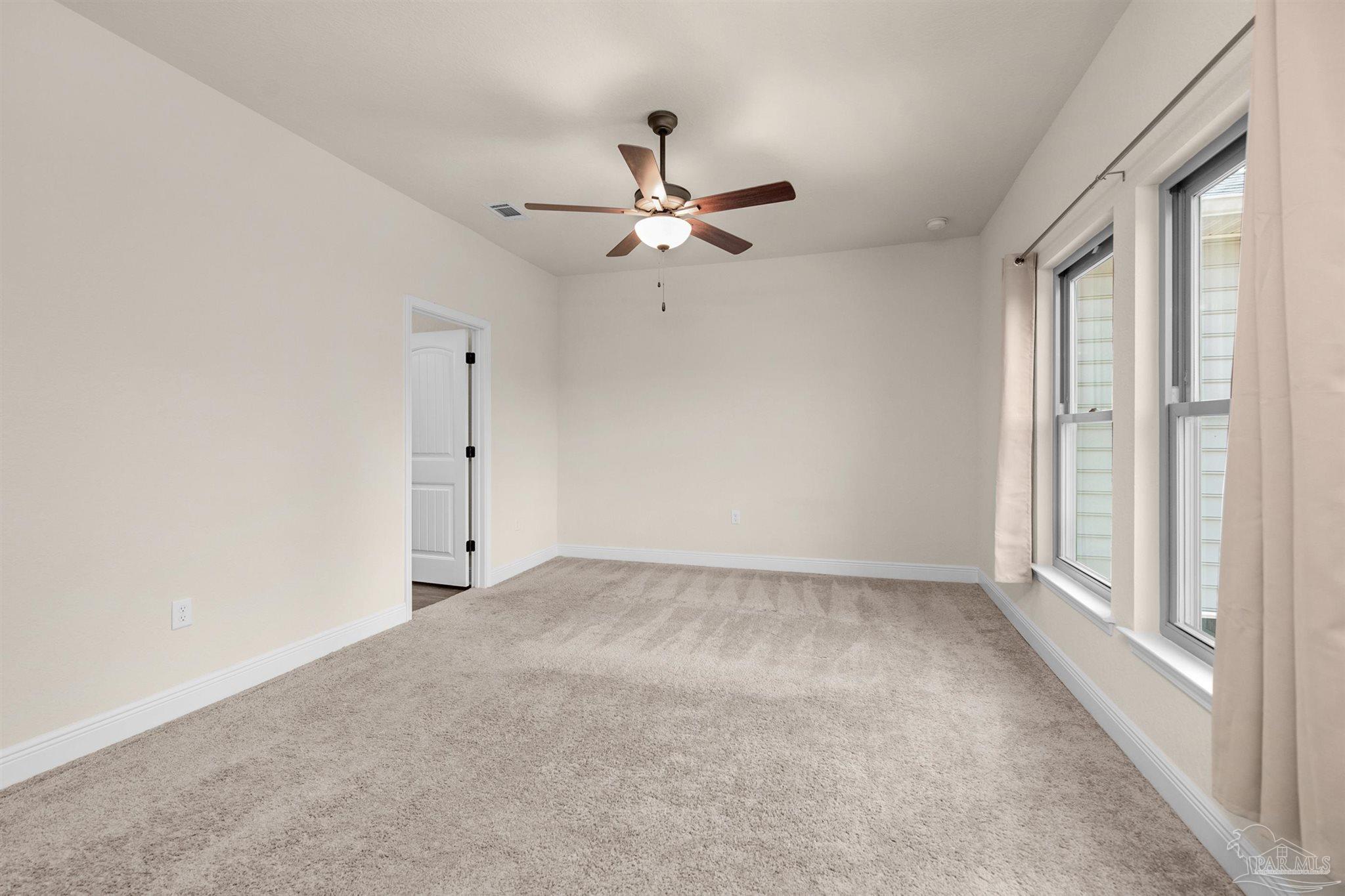 5069 Peach Drive Pace, FL 32571 - Photo 19 of 41 an empty room with fan and windows
