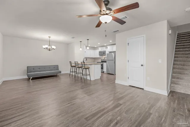 a view of kitchen with furniture and wooden floor