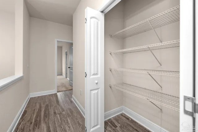 a view of walk in closet with empty racks