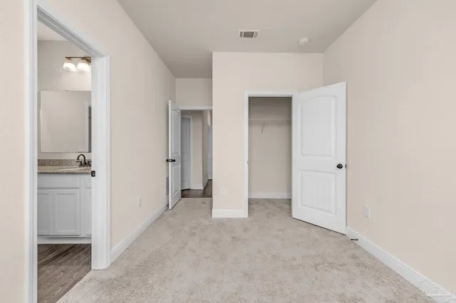 a view of a hallway with closet and entryway