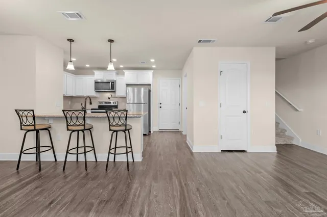 a view of kitchen with furniture and wooden floor
