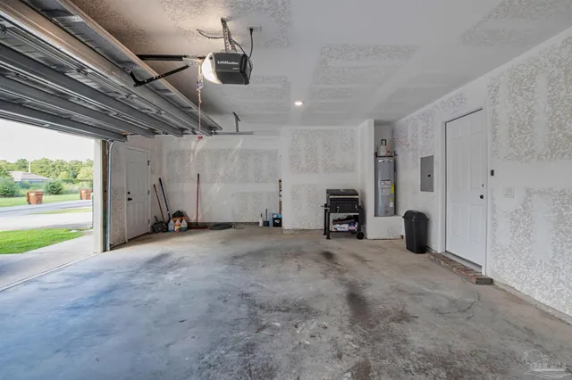 a view of an empty room with a fireplace and a window