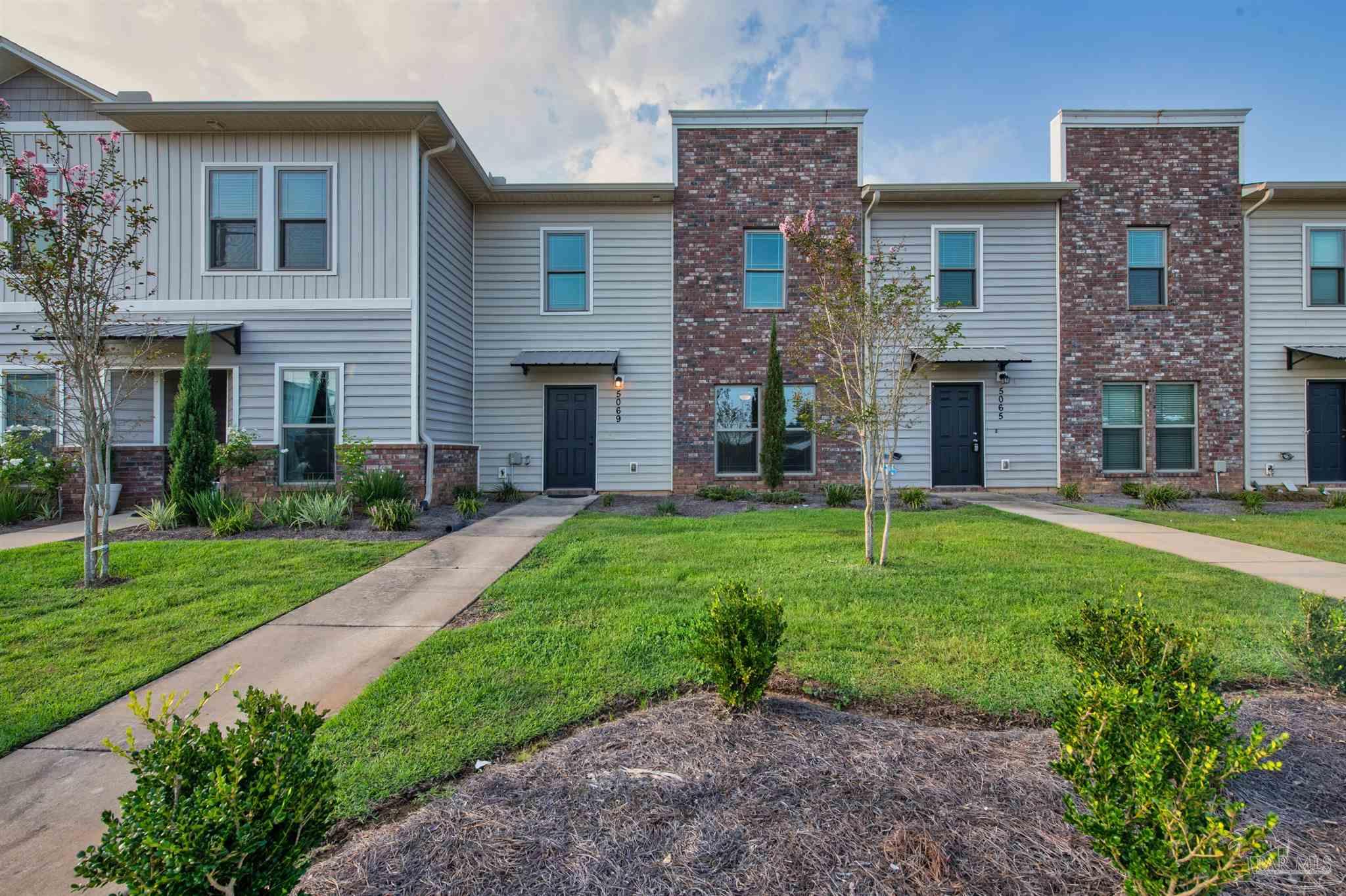 5069 Peach Drive Pace, FL 32571 - Photo 39 of 41 a view of a house with a yard and a large tree