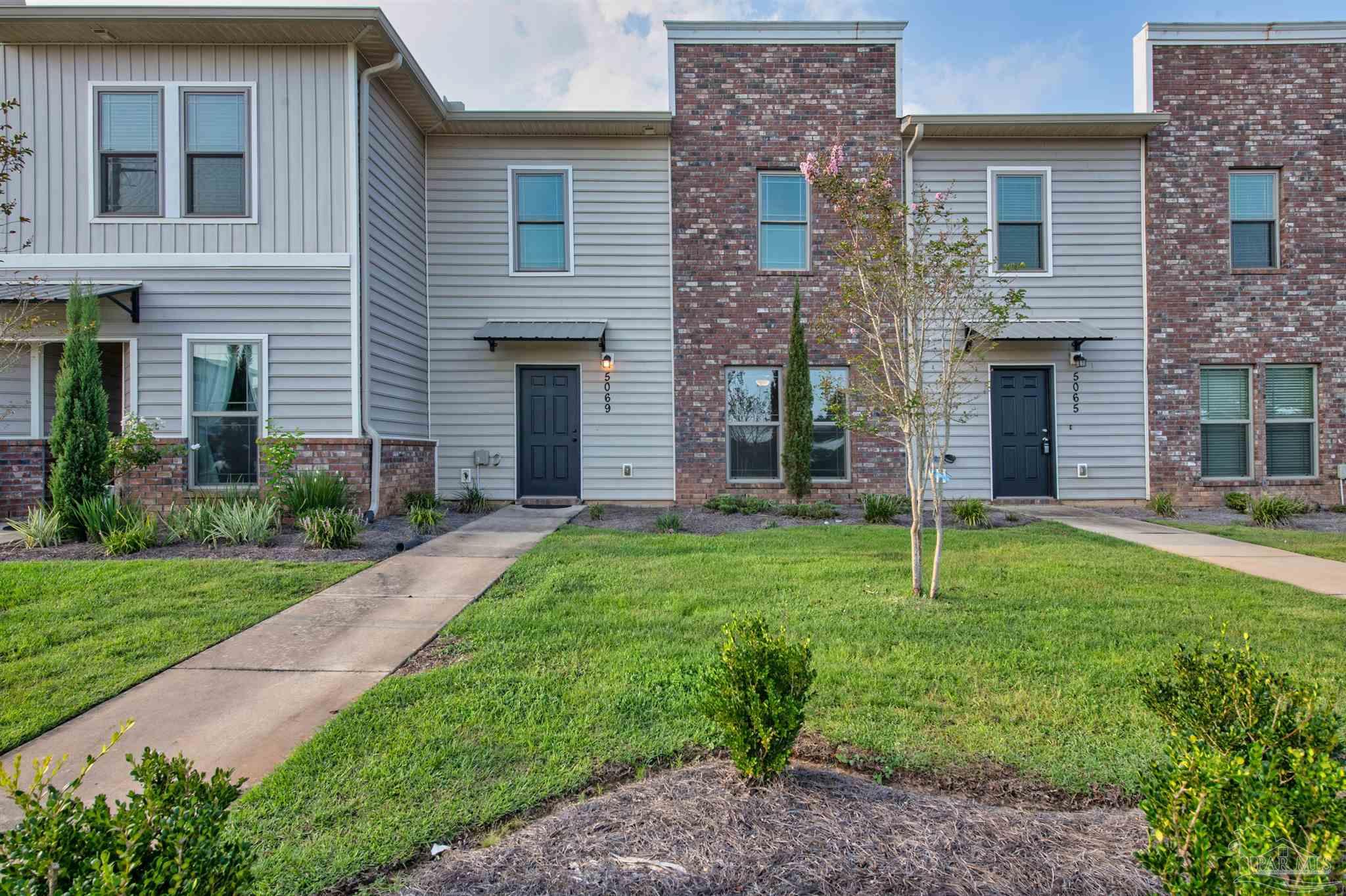 5069 Peach Drive Pace, FL 32571 - Photo 40 of 41 a backyard of a house with plants and large tree