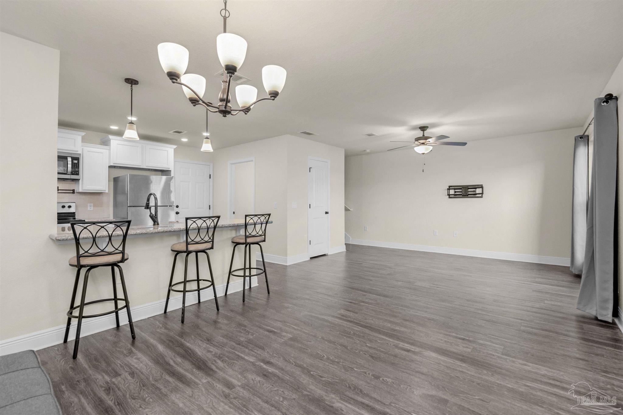 5069 Peach Drive Pace, FL 32571 - Photo 4 of 41 a view of a dining room with furniture and wooden floor