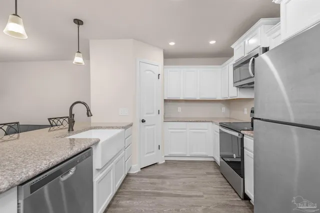 a kitchen with a sink appliances and cabinets