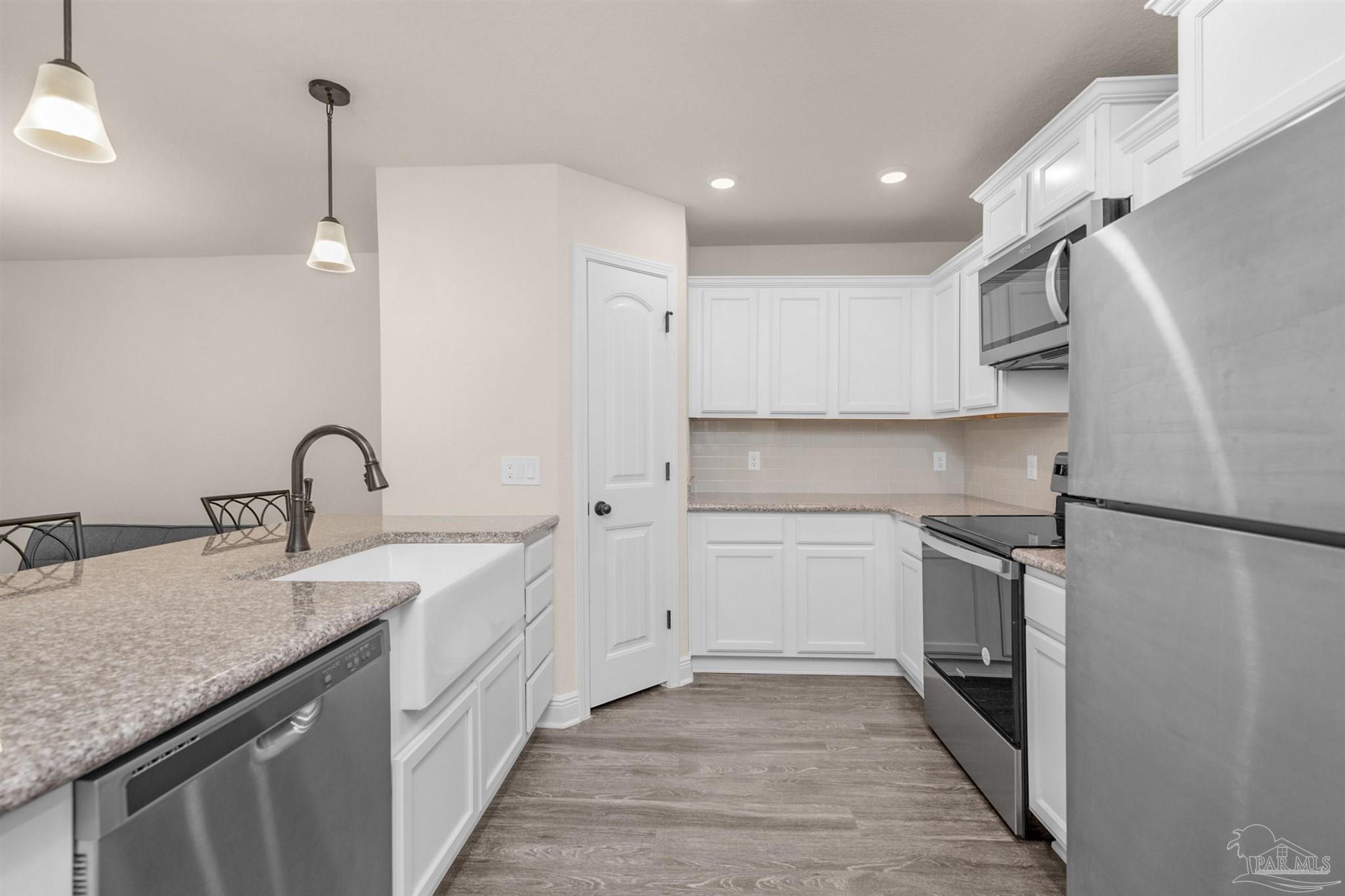 5069 Peach Drive Pace, FL 32571 - Photo 8 of 41 a kitchen with a sink appliances and cabinets