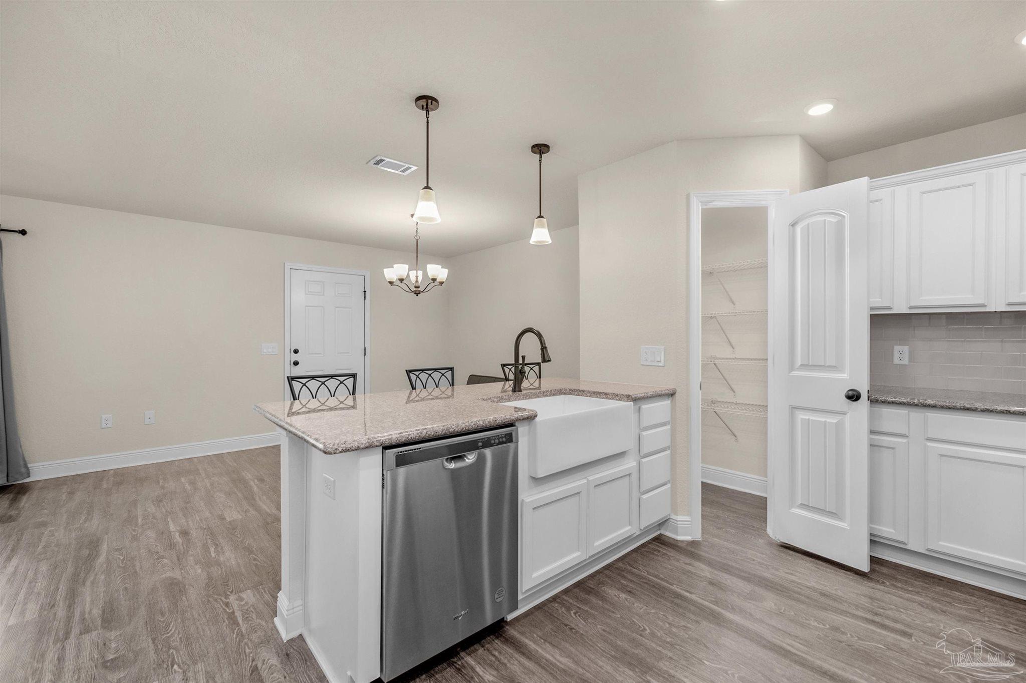 5069 Peach Drive Pace, FL 32571 - Photo 9 of 41 a kitchen with a sink cabinets and wooden floor