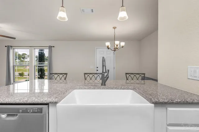 a spacious bathroom with a granite countertop sink a mirror and shower