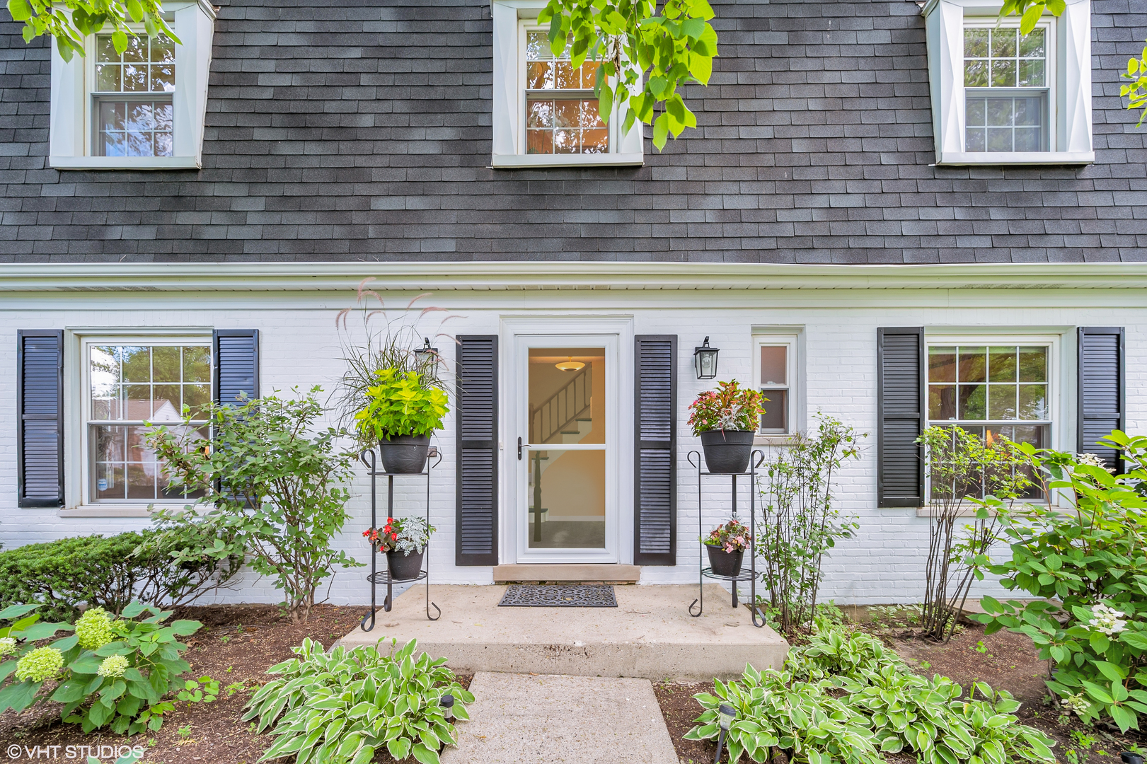 272 Summerfield Road Northbrook, IL 60062 - Photo 2 of 28 front view of a brick house with potted plants