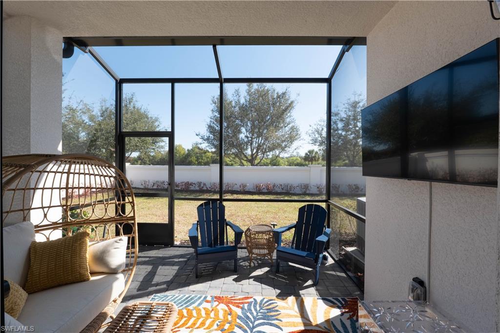 7510 Rockefeller Drive Naples, FL 34119 - Photo 14 of 31 View of patio with a sunroom and glass enclosure