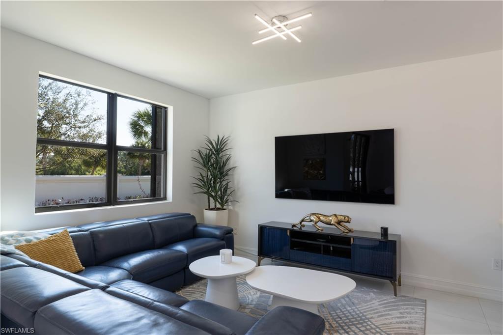 7510 Rockefeller Drive Naples, FL 34119 - Photo 17 of 31 Living area with baseboards and light tile patterned floors