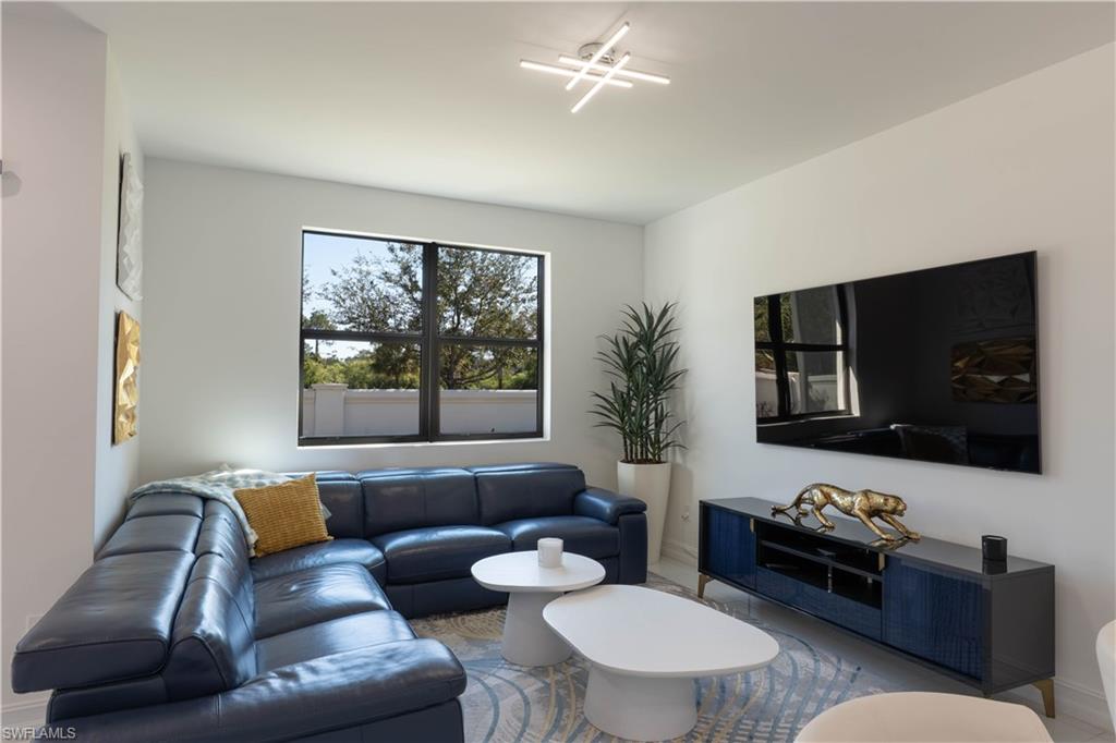 7510 Rockefeller Drive Naples, FL 34119 - Photo 18 of 31 Living room featuring baseboards