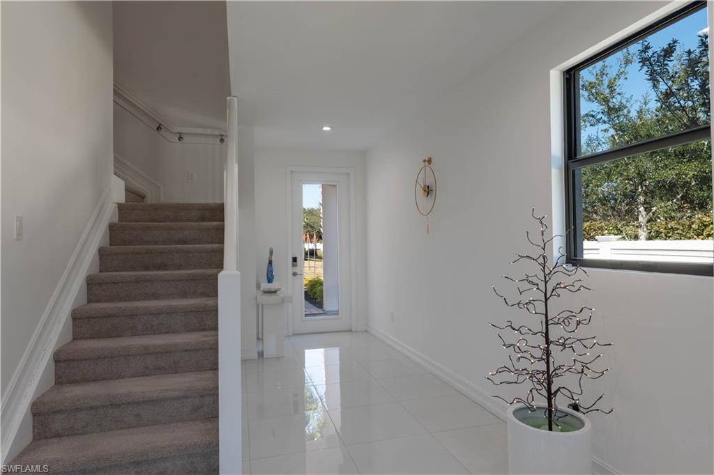 7510 Rockefeller Drive Naples, FL 34119 - Photo 19 of 31 Stairway featuring tile patterned flooring and recessed lighting