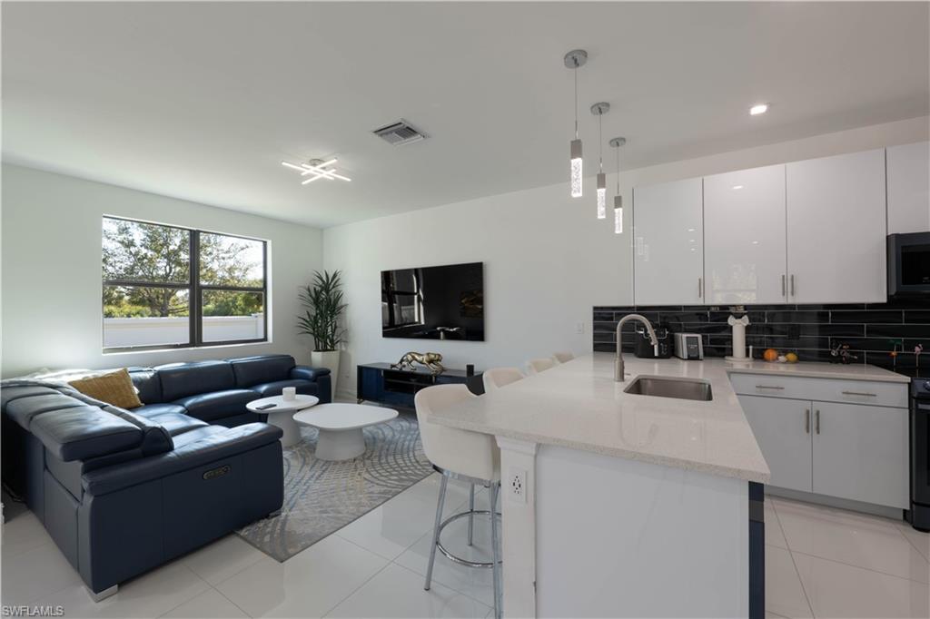 7510 Rockefeller Drive Naples, FL 34119 - Photo 2 of 31 Living area with light tile patterned floors