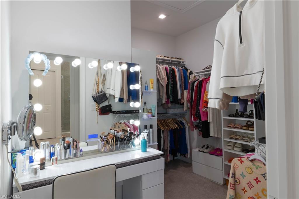 7510 Rockefeller Drive Naples, FL 34119 - Photo 24 of 31 Walk in closet featuring light carpet