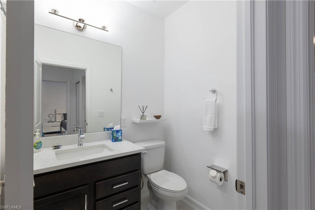 7510 Rockefeller Drive Naples, FL 34119 - Photo 28 of 31 Bathroom with toilet and vanity