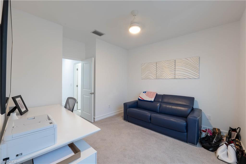 7510 Rockefeller Drive Naples, FL 34119 - Photo 30 of 31 Home office with light carpet and baseboards