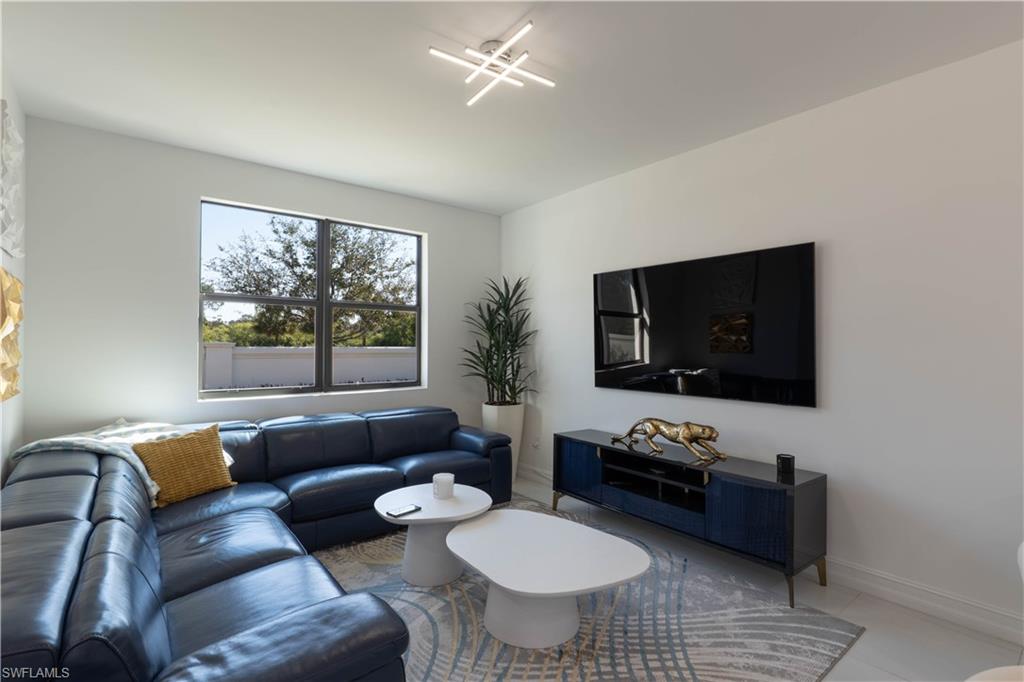 7510 Rockefeller Drive Naples, FL 34119 - Photo 3 of 31 Living room with baseboards and tile patterned floors