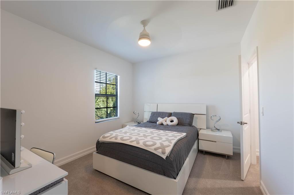 7510 Rockefeller Drive Naples, FL 34119 - Photo 31 of 31 Bedroom with dark carpet