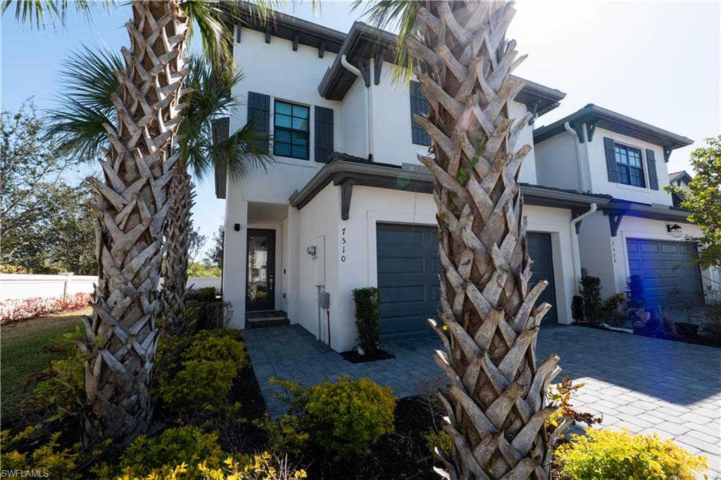 7510 Rockefeller Drive Naples, FL 34119 - Photo 4 of 31 View of front of home featuring stucco siding, a garage, and decorative driveway