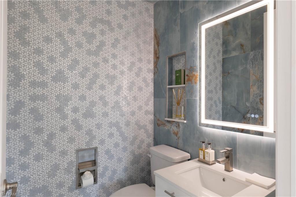 7510 Rockefeller Drive Naples, FL 34119 - Photo 6 of 31 Bathroom featuring vanity and toilet