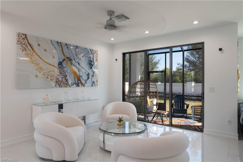 7510 Rockefeller Drive Naples, FL 34119 - Photo 9 of 31 Living area featuring ceiling fan, tile patterned floors, and recessed lighting