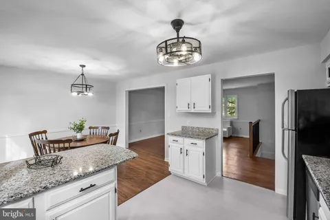 a kitchen with stainless steel appliances granite countertop a sink a stove and refrigerator