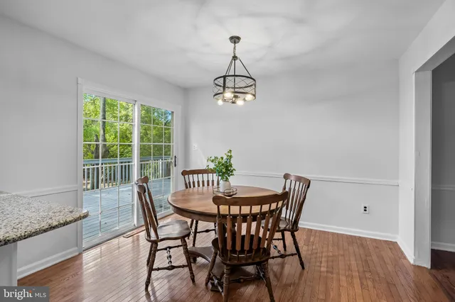 a dining room with furniture window and wooden floor