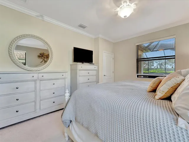 a bedroom with a bed and a chair