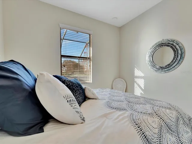 a living room with patio furniture and a garden