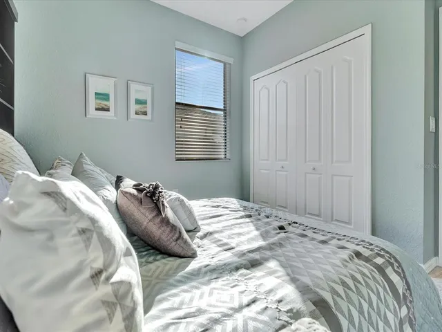 a view of a house with a yard and potted plants