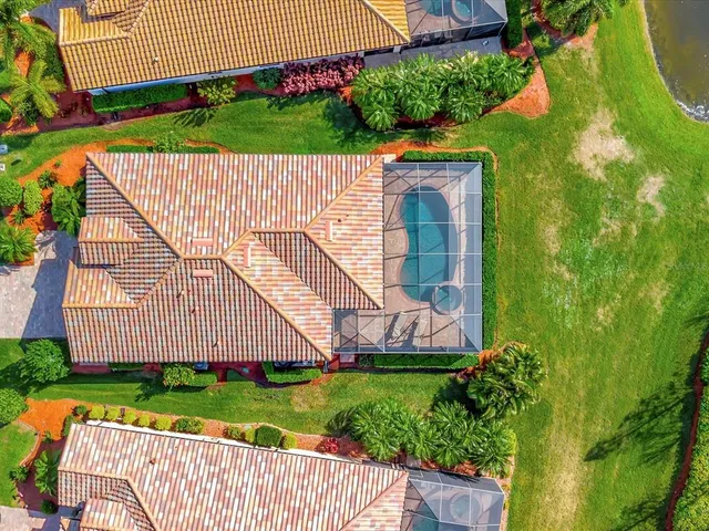 a room with lots of white furniture and chandelier