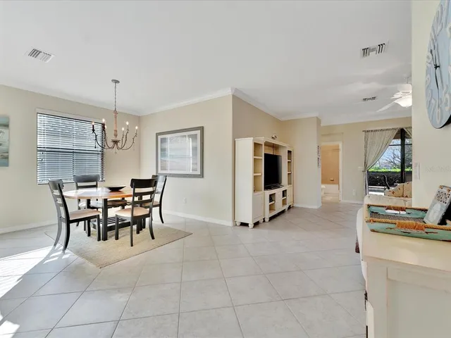 a kitchen with stainless steel appliances granite countertop a refrigerator a stove and a sink with wooden floor