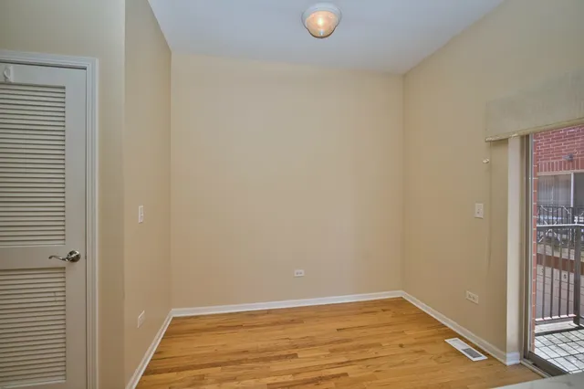 a view of a room with wooden floor