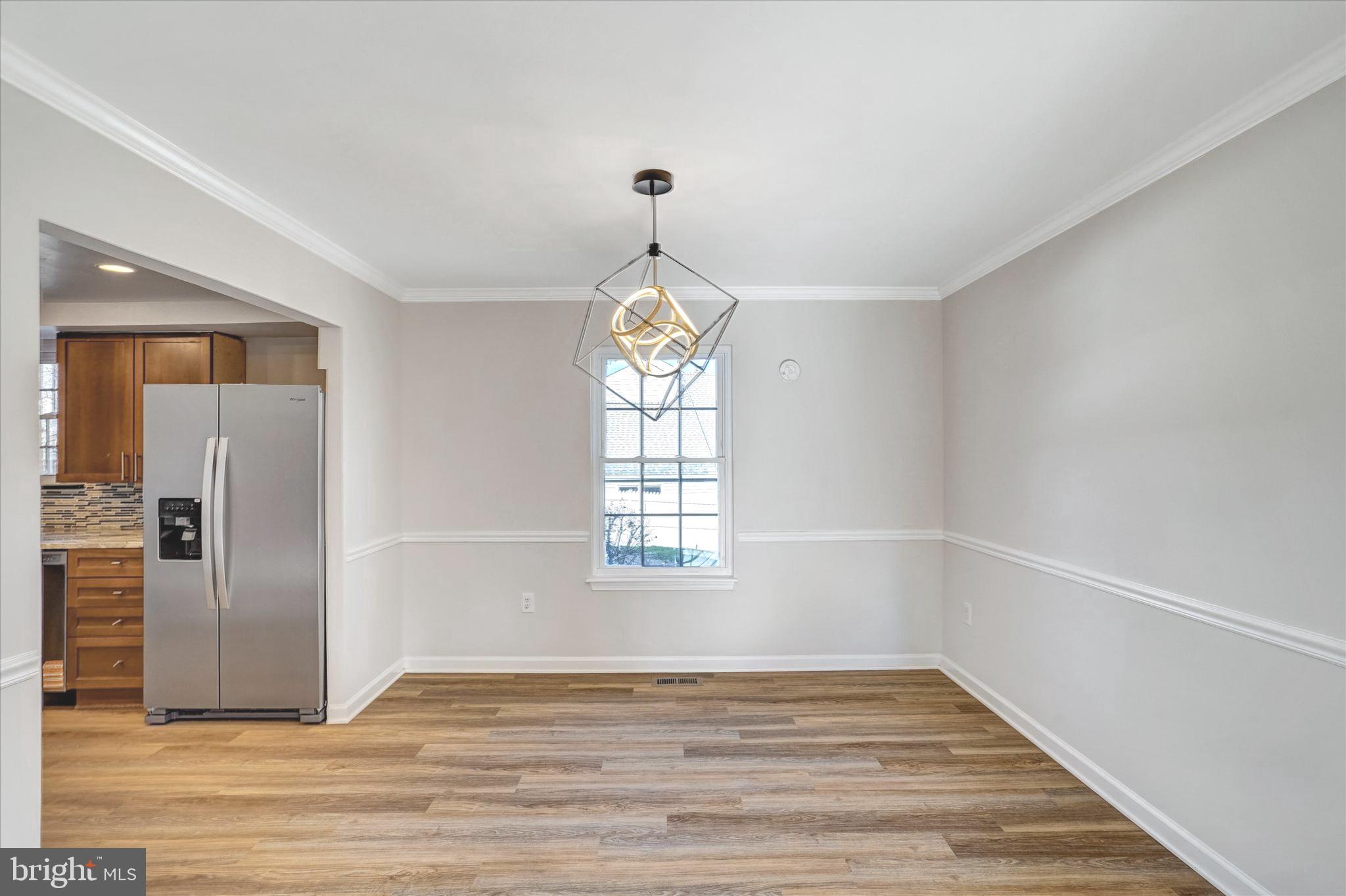 1324 Rock Chapel Road Herndon, VA 20170 - Photo 11 of 42 an empty room with wooden floor cabinet and windows