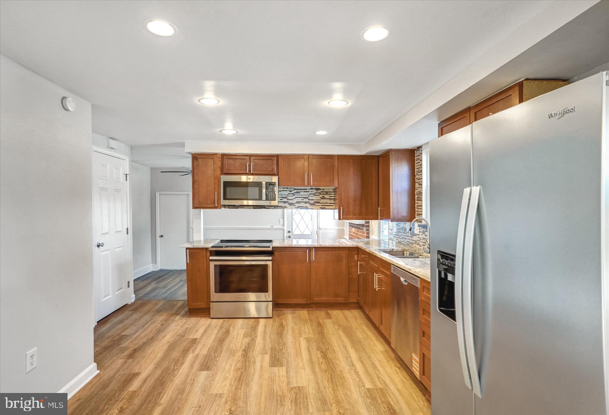 1324 Rock Chapel Road Herndon, VA 20170 - Photo 12 of 42 a kitchen with stainless steel appliances granite countertop a sink and stove top oven