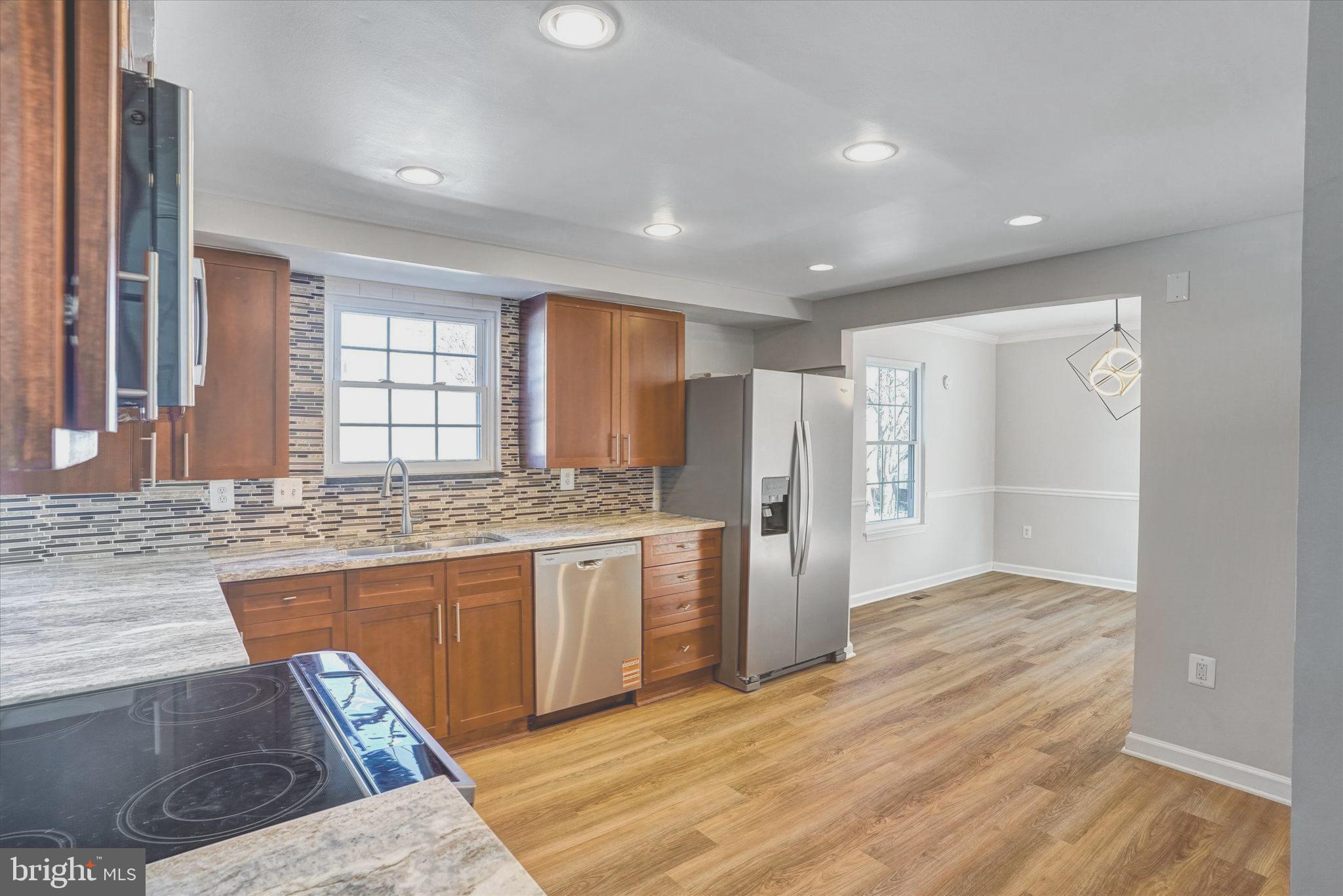 1324 Rock Chapel Road Herndon, VA 20170 - Photo 14 of 42 a kitchen with stainless steel appliances granite countertop a refrigerator and a sink